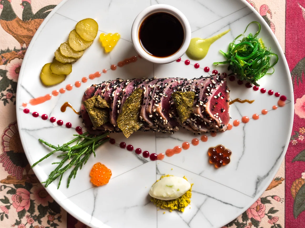 Tapabento's sliced tuna tataki with sesame, seaweed, pickles, and dipping sauce.